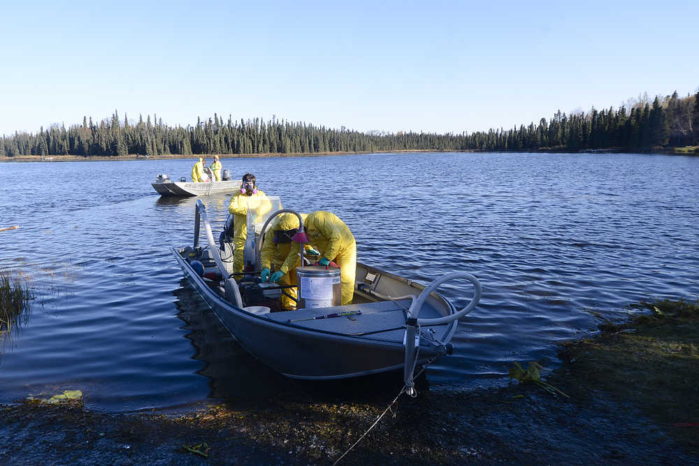Photo by Rashah McChesney/Peninsula Clarion  Several agencies teamed up with the Alaska Department of Fish and Game as it treated four lakes in the Soldotna Creek drainage during the second week of October. Here, researchers mix the fish-killing rotenone before it is pumped into East Mackey Lake on Wednesday October 8, 2014 in Soldotna, Alaska.