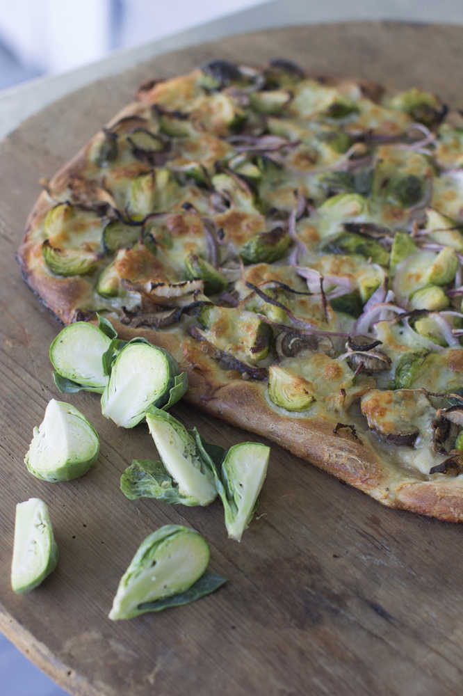 This Sept. 22, 2014 photo shows a Brussels sprout pizza in Concord, N.H. Chic menus at restaurants around the country have begun serving Brussels sprouts after kale introduced Americans to the idea that there actually are many ways to prepare most vegetables. (AP Photo/Matthew Mead)