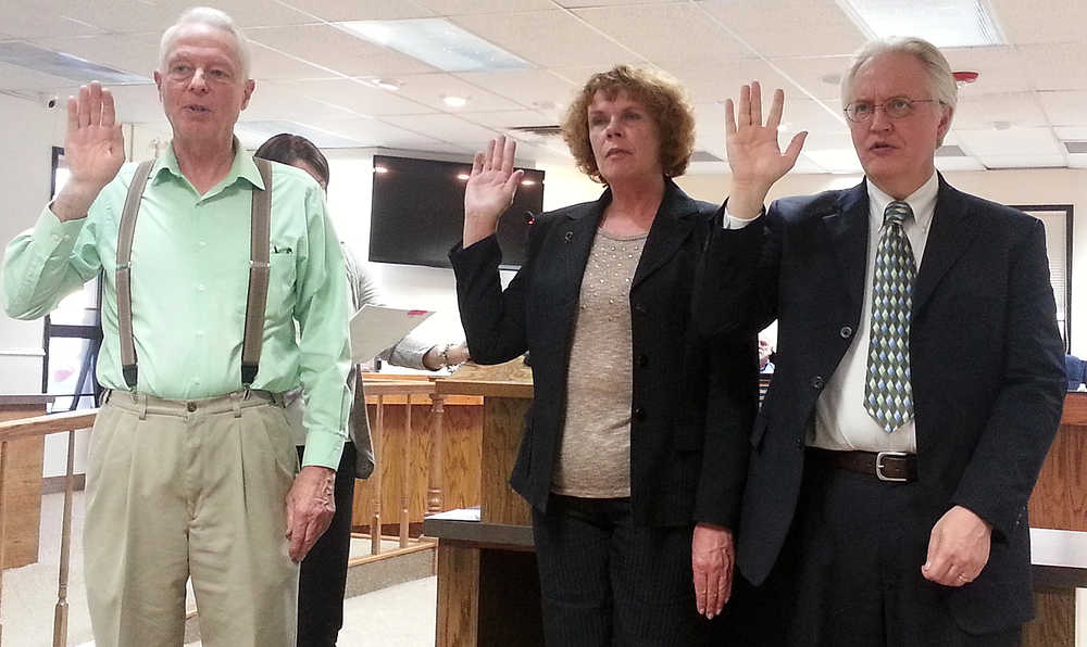 Photo by Dan Balmer/Peninsula Clarion Three newly elected Kenai Peninsula Borough Assembly members get sworn-in to office at the assembly meeting Tuesday in Soldotna. (From left) Stan Welles will replace Charlie Pierce on the Sterling and Funny River district, Kelly Cooper will replace Bill Smith for the Homer district seat, and Blaine Gilman was elected to replace outgoing Kenai district member Hal Smalley.