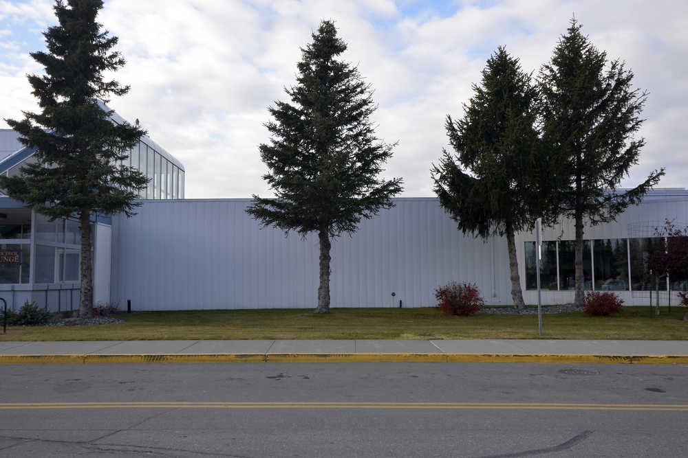 Photo by Dan Balmer/Peninsula Clarion The Kenai City Council recommended a 30-foot tall fir tree (pictured middle) be cut down when the mural "Kenai La Belle" is installed on the exterior of the Kenai Municipal Airport between the arrival and departure doors. The installation and tree removal dates have not yet been determined.