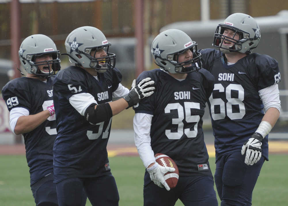 From left, Trevor Walden, Adrian Gomez-Dickson, Drew Fowler and Matt Trammell celebrate Fowler's interception and touchdown.  Photo by Michael Dinneen for the Clarion.