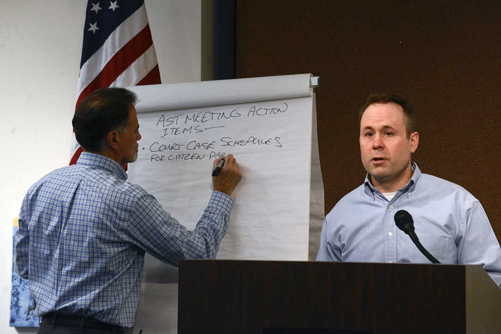 Photo by Rashah McChesney/Peninsula Clarion Sen. Peter Micciche, R-Soldotna, writes action items on a board while District Attorney Scot Leaders leads a discussion during a town hall meeting on burglary and drug-related crime at the Kenai Chamber of Commerce and Visitors Center on Saturday Oct. 18, 2014 in Kenai, Alaska.