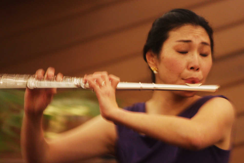 Photo by Kelly Sullivan/ Peninsula Clarion Local flautist Tomoko Raften performing at Christ Lutheran of Soldotna, Thursday Oct. 17, 2014, in Soldotna, Alaska.