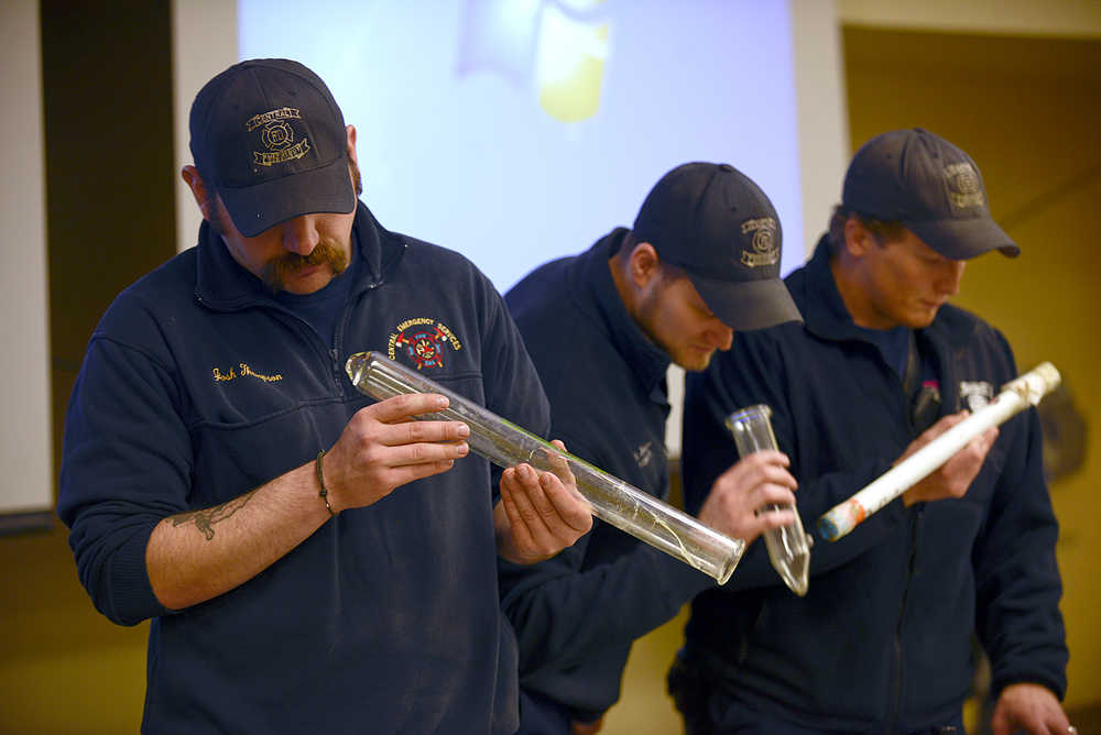 Photo by Rashah McChesney/Peninsula Clarion Central Emergency Services firefighters Josh Thompson, Matt Seizys and Jason Cooper look at paraphernalia used for making hash oil, a cannabis derivative, after a presentation from a fire investigator from Aurora, Colorado on Wednesday October 22, 2014 in Soldotna, Alaska.