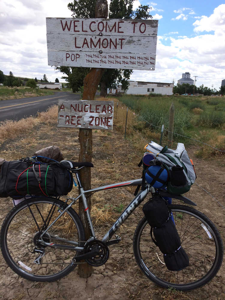 Photo courtesy Tyler Peek Nikiksi resident Tyler Peek takes a break in Lamont, Iowa during his bike trek accross the country through all the Lower 48 states, a distance of 6,850 miles.