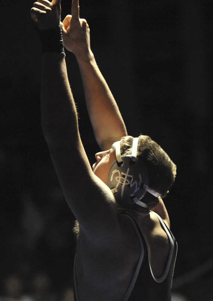 Nikiski's Luke Johnson celebrates his 195-pound finals victory over Scott Carpenter of Bethel High School in the high school division 1-2-3A wrestling championships Saturday, Dec. 14, 2013 in Anchorage, Alaska.  (AP Photo / Michael Dinneen)