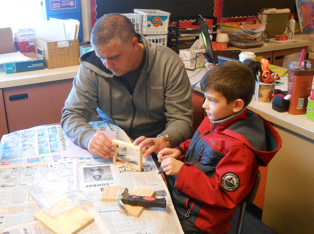 For the birds Carson Grimm and his dad, Ryan Grimm, work together to build a bird feeder during an after-school parent/child activity for second graders sponsored by the Title I program at Mountain View Elementary School in Kenai. Students had to read the instructions to their parents and then work together to build the bird feeder. Families learned about bird feeder safety and what birds might come to their bird feeders, and took home some bird seed.