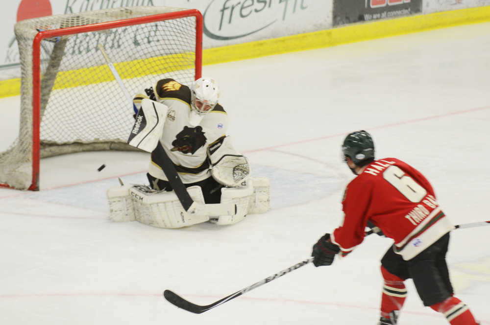 Photo by Kelly Sullivan/ Peninsula Clarion Kenai River Brown Bears' goalie Alec Derks blocks a shot from Minnesota Wilderness Tommy Hall for the puck Friday, October 24, 2014 at the Soldotna Regional Sports Complex in Soldotna, Alaska.