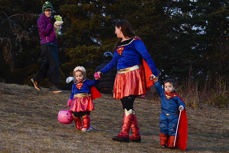 Photo by Rashah McChesney/Peninsula Clarion  Tatum O'Brien, 3, runs from her mother during the Tsalteshi Trails Association's Spook Night Trick-or-Treat Trail and Fun Run Sunday October 26, 2014 in Soldotna, Alaska.