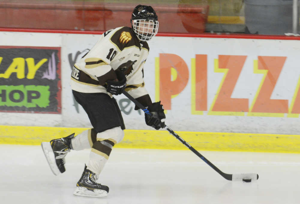 Photo by Kelly Sullivan/ Peninsula Clarion Kenai River Brown Bears Tanner Schachle gets control of the puck and sprints down the rink Friday, October 24, 2014 at the Soldotna Regional Sports Complex in Soldotna, Alaska.