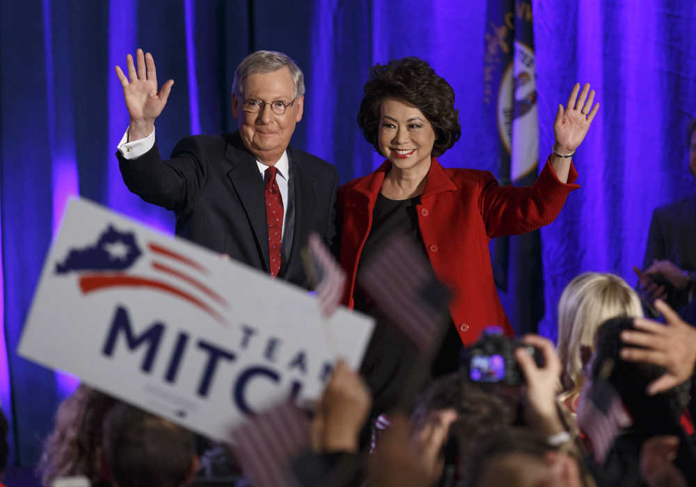 Senate Minority Leader Mitch McConnell of Ky.,  joined by his wife, former Labor Secretary Elaine Chao, celebrates with his supporters at an election night party in Louisville, Ky.,Tuesday, Nov. 4, 2014. McConnell won a sixth term in Washington, with his eyes on the larger prize of GOP control of the Senate. The Kentucky Senate race, with McConnell, a 30-year incumbent, fighting off a spirited challenge from Democrat Alison Lundergan Grimes, has been among the most combative and closely watched contests that could determine the balance of power in Congress. (AP Photo/J. Scott Applewhite)