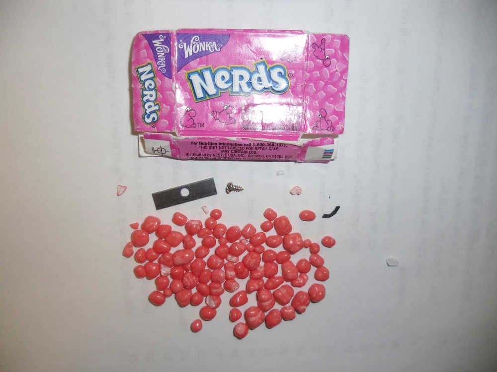 Photo courtesy Soldotna Police Department A razor blade and screw was found in this box of Nerds candy by the parent of a 13-year-old Soldotna teen on Halloween night. Police are investigating how the metal got into the packaging. Police believe the candy was obtained near the 200 and 300 block between Central Peninsula Hospital and Soldotna High School.