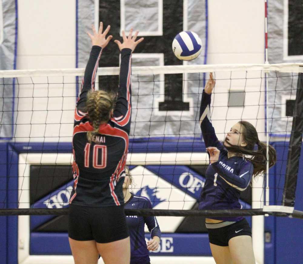 Soldotna's Judah Aley pushes the ball over the block of Kenai's Abby Beck during a 3-1 win over the Kards in the first round of the Northern Lights Conference Volleyball Championships at Palmer High School Thursday.