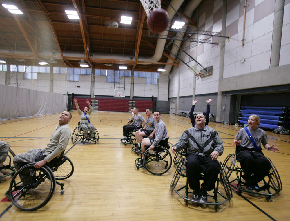 ADVANCE FOR USE MONDAY, NOV. 10 - In this photo taken on Monday, Nov. 3, 2014, members of the Bravo Company Warrior Transition Unit on Fort Wainwright participate in adaptive sports, including wheelchair basketball, at the post's Physical Fitness Center near Fairbanks, Alaska, as the U.S. Army honors wounded, ill and injured soldiers and their families by commemorating November as Warrior Care Month. (AP Photo/Fairbanks Daily News-Miner, Eric Engman) MAGS OUT