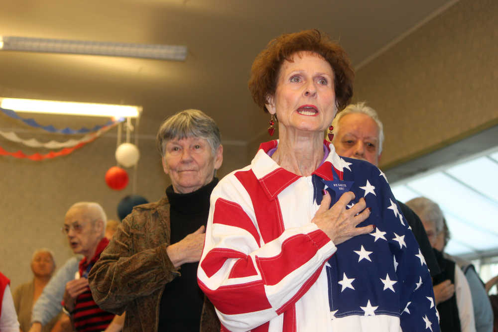 Photo by Dan Balmer/Peninsula Clarion A salute to our veterans Kenai resident Betty Osborn, retired from service in the U.S. Air Force, stands for the signing of "The Star-Spangled Banner" and posting of the colors Monday at the Kenai Senior Center. The community gathered for an evening of remembrance and celebration of veteran's the day before Veteran's Day.
