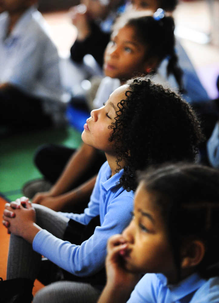 Mary-Kate Boyles, 7, gets lost in the music during a webcast by the Detroit Symphony Orchestra to students at Yes Academy Wednesday, Nov. 12, 2014, in Detroit.  Boyles sayd, "This was the first day I've ever heard it.  It was beautiful." (AP Photo/Detroit News,  Daniel Mears)  DETROIT FREE PRESS OUT; HUFFINGTON POST OUT, MAGS OUT, MANDATORY CREDIT