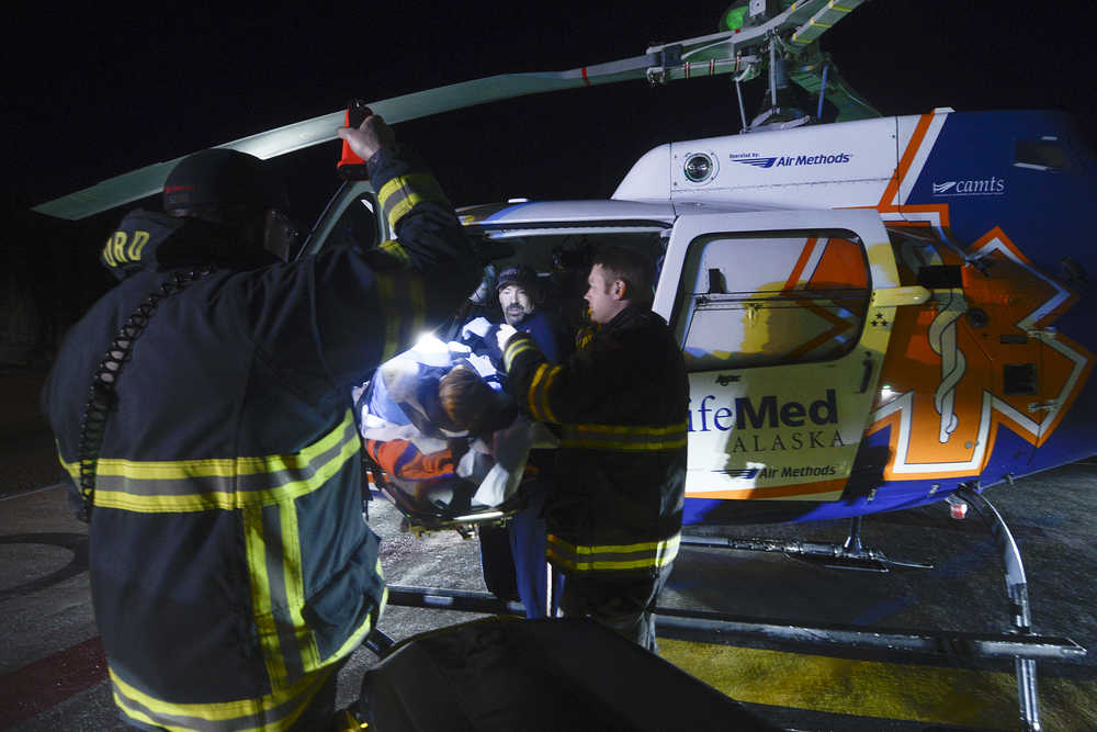 Photo by Rashah McChesney/Peninsula Clarion  Brooke Marcotte, Kenai PRL Logistics facility coordinator, plays the victim during an emergency drill at the new PRL Logistics facility at Kenai Landing on Friday Nov. 14, 2014 in Kenai, Alaska.  The drill involved members of Alaska LNG, Kenai Firefighters, Central Emergency Services and LifeMed Alaska crews coordinating a rescue using the facility's new helipad.