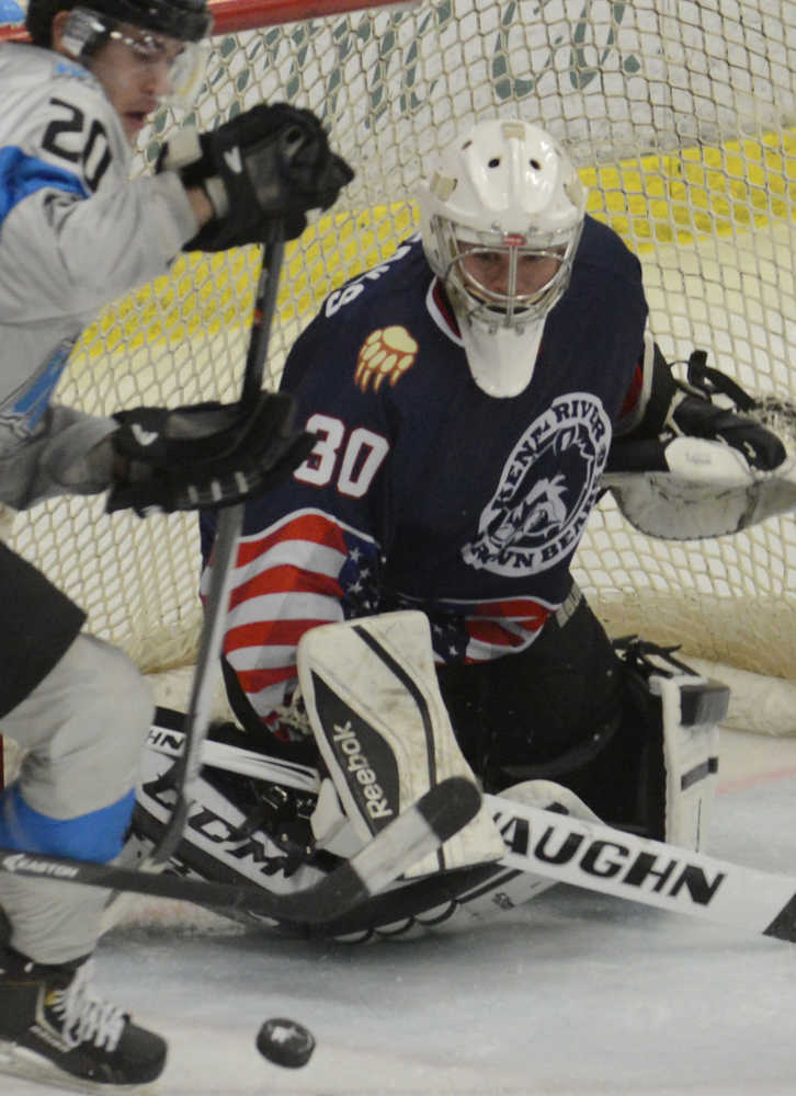 Photo by Kelly Sullivan/ Peninsula Clarion Kenai River Brown Bears' number 30, Alec Derks, blocks a shot by Wenatchee Wild's number 20, Shane Bennett, Friday, Nov. 21, 2014 at the Soldotna Regional Sports Complex in Soldotna, Alaska.