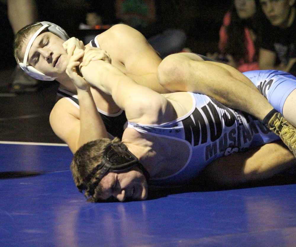 Nikiski's Luke Johnson tries to turn Chugiak's Jesse Nelson during the 220-pound final of the Lancer Smith Memorial Nov. 22 at Palmer High School. Johnson pinned Nelson in the final round.