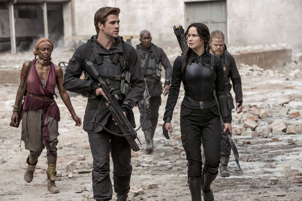 In this image released by Lionsgate, Jennifer Lawrence portrays Katniss Everdeen, right, and Liam Hemsworth portrays Gale Hawthorne in a scene from "The Hunger Games: Mockingjay Part 1." (AP Photo/Lionsgate, Murray Close)