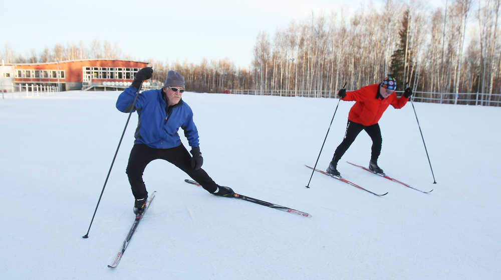 ADVANCE FOR WEEKEND EDITIONS, NOV. 29-30 - In this photo taken on Nov. 17, 2014, Nordic ski instructor Tim Buckley, left, stresses the importance of stretching as he works with beginning classic cross country skiing students from the Osher Lifelong Learning Institute at UAF during their class at Birch Hill Recreation Area in Fairbanks, Alaska.  Buckley, 70, is a lifelong skier and has been teaching both classic and skate techniques to children and adults for 15 years. Buckley is the Spotlight for the week.  (AP Photo/Fairbanks Daily News, Miner, Eric Engman)