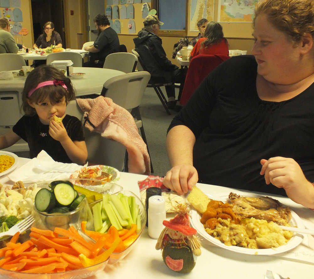 Ben Boettger/Peninsula Clarion PollyAnna Makabe (right) and Rye Cross at the Salvation Army Community Dinner on Thursday, Nov. 27. "We came to the dinner because we just moved down here from Wasilla, and don't know anyone yet," said Cross. "I didn't want to make a Thanksgiving dinner for just two."