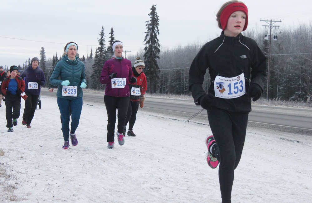 Photo by Kelly Sullivan/ Peninsula Clarion Runners cover the Unity Trail during the T200 Turkey Trot 5k and 10k Run, Friday, Nov. 28, 2014, at the Soldotna Regional Sports Complex in Soldotna, Alaska. Tsalteshi Trails Association teamed up Tustumena 200 Sled Dog Race for this year's fourth annual event.