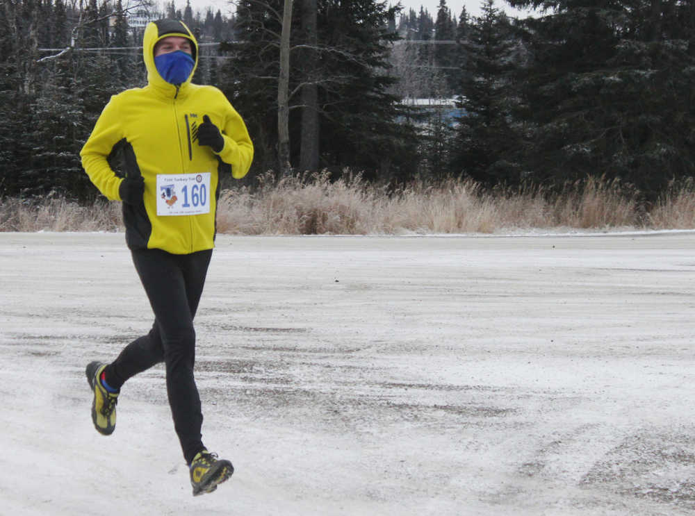 Photo by Kelly Sullivan/ Peninsula Clarion Jamie Nelson sprinted to the finish after running the Unity Trail for the T200 Turkey Trot 5k and 10k Run, Friday, Nov. 28, 2014, at the Soldotna Regional Sports Complex in Soldotna, Alaska. Tsalteshi Trails Association teamed up Tustumena 200 Sled Dog Race for this year's fourth annual event.