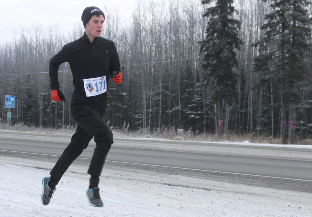 Photo by Kelly Sullivan/ Peninsula Clarion Jordan Theisen came in first after running the Unity Trail during the T200 Turkey Trot 5k and 10k Run, Friday, Nov. 28, 2014, at the Soldotna Regional Sports Complex in Soldotna, Alaska. Tsalteshi Trails Association teamed up Tustumena 200 Sled Dog Race for this year's fourth annual event.