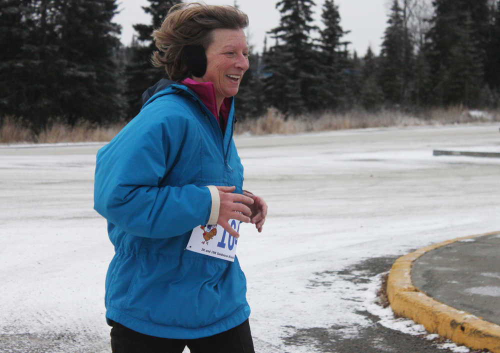 Photo by Kelly Sullivan/ Peninsula Clarion Jane Fuerstenau ran the Unity Trail for the T200 Turkey Trot 5k and 10k Run, Friday, Nov. 28, 2014, at the Soldotna Regional Sports Complex in Soldotna, Alaska. Tsalteshi Trails Association teamed up Tustumena 200 Sled Dog Race for this year's fourth annual event.