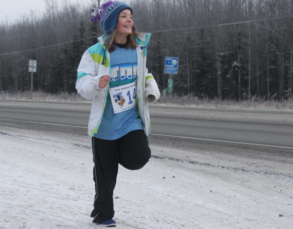 Photo by Kelly Sullivan/ Peninsula Clarion runs on the Unity Trail during the T200 Turkey Trot 5k and 10k Run, Friday, Nov. 28, 2014, at the Soldotna Regional Sports Complex in Soldotna, Alaska. Tsalteshi Trails Association teamed up Tustumena 200 Sled Dog Race for this year's fourth annual event.