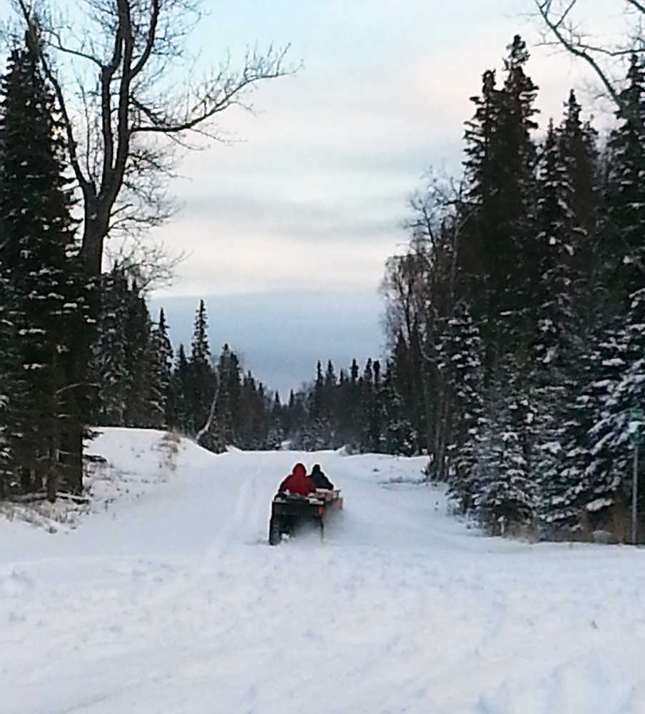 Photo by Dan Balmer/Peninsula Clarion Two Gray Cliffs property owners take off on all-terrain vehicles at the end of the Kenai Spur Highway to access their property Wednesday. The property owners said they cannot get to their land by vehicle because of the rough terrain. Apache Alaska Corporation has proposed a 7.5-mile extension of the Spur Highway to the Gray Cliffs subdivision that would benefit their oil and gas exploration as well as property owners.