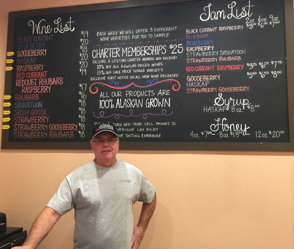 Brian Olson stands behind the wine tasting counter at Alaska Berries