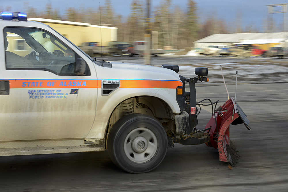 Photo by Rashah McChesney/Peninsula Clarion  AIMM Monofill Inc., representative Scott Anderson discusses a drilling mud spill with Brian Gabriel, Alaska Department of Transportation station manager, on Tuesday Dec. 9, 2014 in Nikiski, Alaska. The mud was spilled from a truck delivering mud to the monofill.