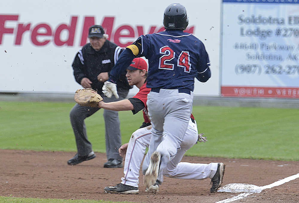 Photo by Rashah McChesney/Peninsula Clarion  Peninsula Oilers' Adam Sonabend waits for a catch as Chugiak-Eagle River Chinooks' Chance Gusbeth heads to first during their game Friday July 5, 2013 in Kenai, Alaska.