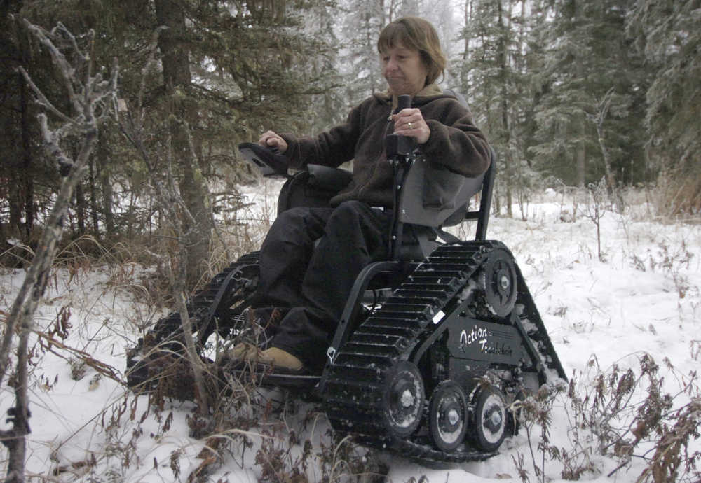 Ben Boettger/Peninsula Clarion Jill Erickson maneuvers her Action Trackchair through her wooded property on Friday, Dec. 12.