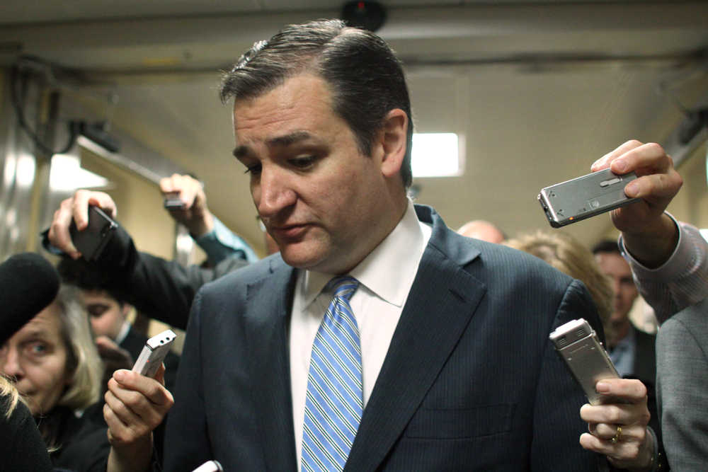 Sen. Ted Cruz, R-Texas talks with reporters on Capitol Hill in Washington, Friday, Dec. 12, 2014, as the Senate considers a spending bill. The House has passed an additional stopgap spending to make certain the government doesn't shut down at midnight Saturday when current funding authority runs out. The move would give the Senate additional time to process a $1.1 trillion government-wide spending bill.  (AP Photo/Lauren Victoria Burke)