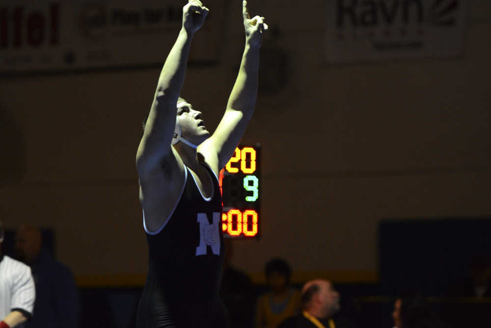 Photo by Joey Klecka/Peninsula Clarion  Nikiski junior Luke Johnson points toward the sky in celebration of his 220-pound state title victory at the Class 1-2-3A state wrestling championships, Saturday at Bartlett High School in Anchorage, Alaska.