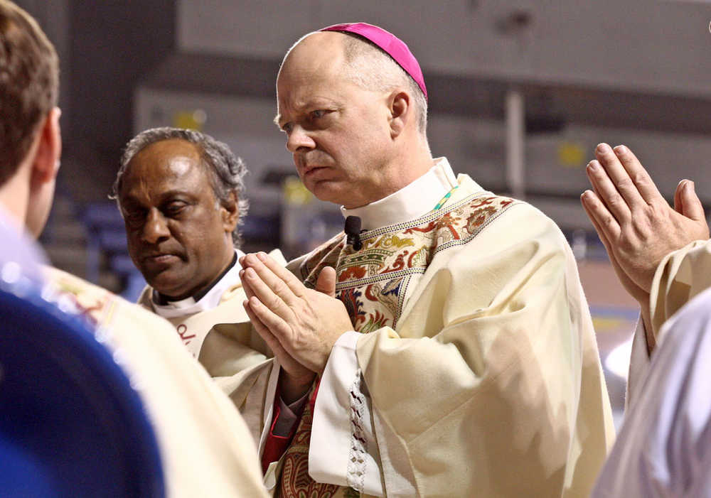 In this photo taken Monday, Dec. 15, 2014, the Most Reverend Chad W. Zielinski is questioned during his Ordination and Installation as the Sixth Bishop of the Diocese of Fairbanks, at the Carlson Center in Fairbanks, Alaska. (AP Photo/Fairbanks Daily News-Miner, Eric Engman) MAGS OUT, NO SALES