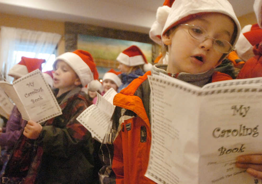 Photo by Kelly Sullivan/ Peninsula Clarion Mountain View Elementary second-grader Alex Collett incorporated some dance moves into his caroling at Charis Place Assisted Living Wednesday, Dec. 17, 2014 in Kenai, Alaska. Collett performed five carols with his classmates.