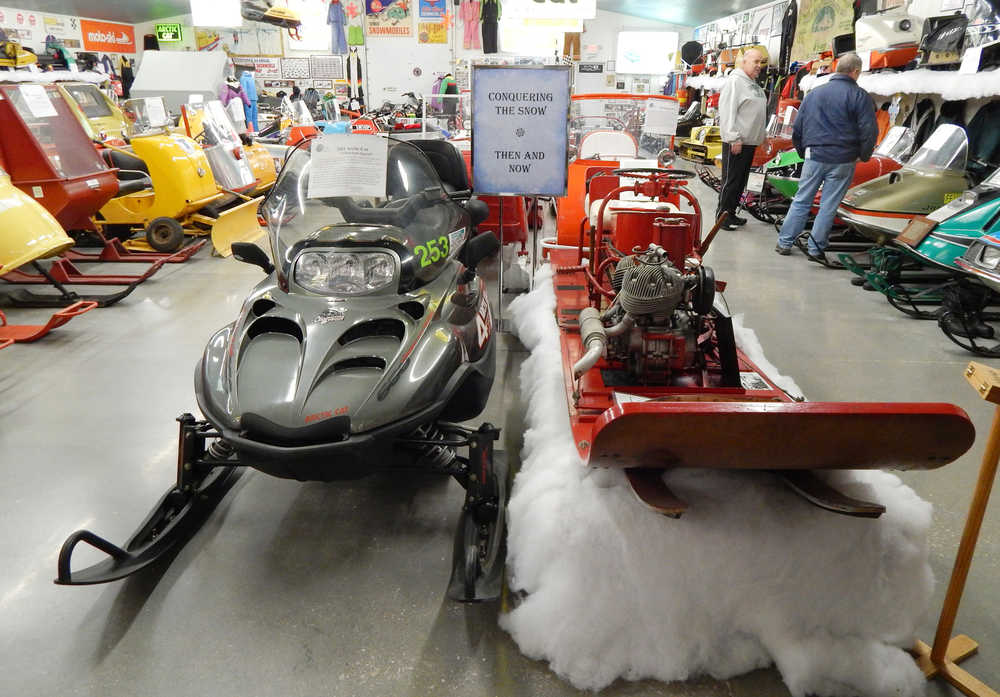 In a Dec. 10, 2014 photo, the Top of the Lake Snowmobile Museum, located just off US-2 in Naubinway, Mich., features 80 different brands of snowmobiles and nearly 150 displays - like this "Then and Now" feature which showcases past and present designs. Of the old machines represented, many are one-of-a-kind creations _ either special prototypes or homemade machines by barnyard engineers. (AP Photo/The Evening News, Scott Brand)