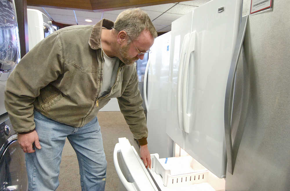 Photo by Rashah McChesney/Peninsula Clarion  Rich Bartolowits does some shopping for himself in the days before Christmas on Dec. 23, 2014 at Dan's TV and Appliance in Kenai, Alaska.