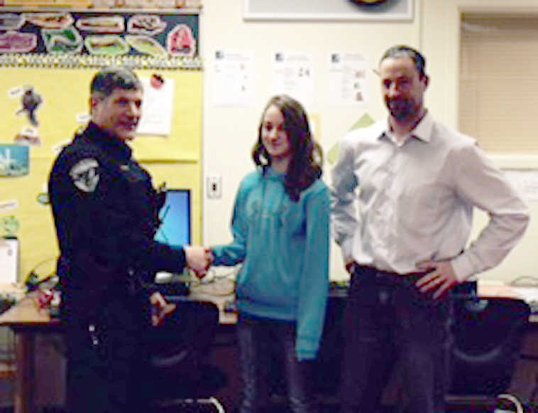 Lila McKay and her father, Robert McKay, are congratulated by Soldotna Police Chief Peter Mlynarik. (Submitted photo)