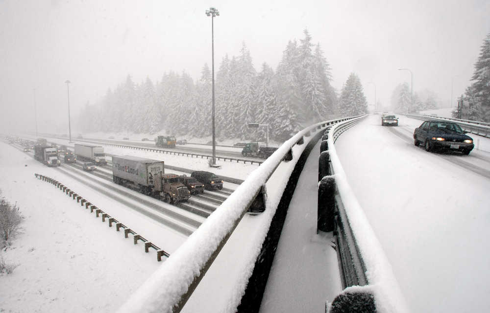 FILE -- In this March 9, 2009 file photo, freeway traffic slows to a crawl along I-5 northbound near Everett, Wash. Many of the chemicals spread on highways to help winter drivers can damage the environment. Researchers at Washington State University are working on environmentally friendly ways that use less salt to reduce snow and ice on roads. (AP Photo/The Herald, Kevin Nortz, File)