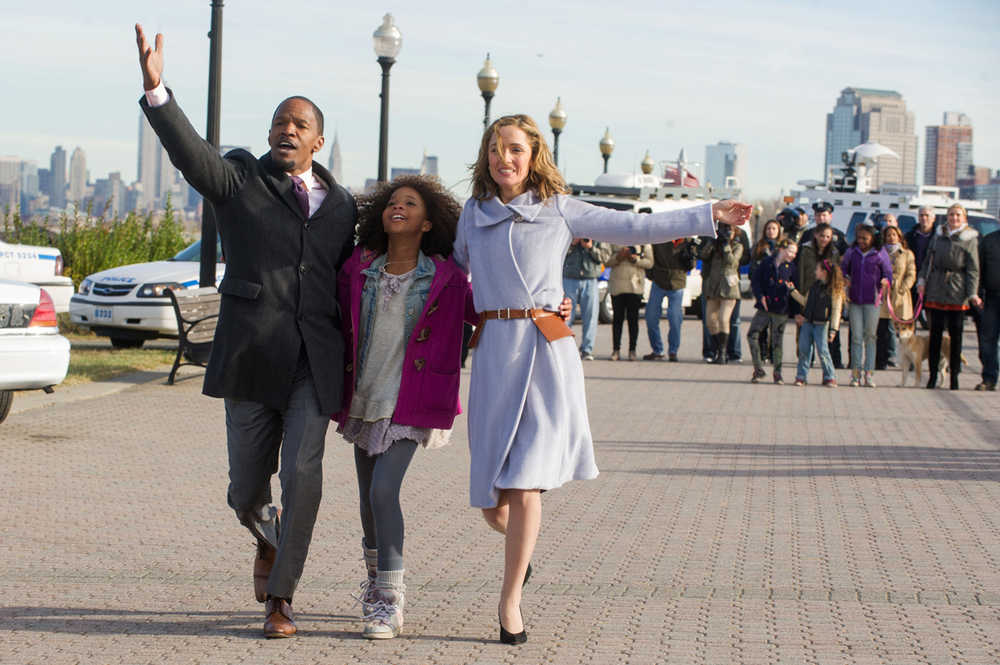 This photo released by Colombia Pictures - Sony shows, from left, Jamie Foxx as Will Stacks, Quvenzhane Wallis, as Annie, and Rose Byrne as Grace, singing "I Don't Need Anything But You" in a scene from Columbia Pictures' "Annie." (AP Photo/Columbia Pictures - Sony, Barry Wetcher)