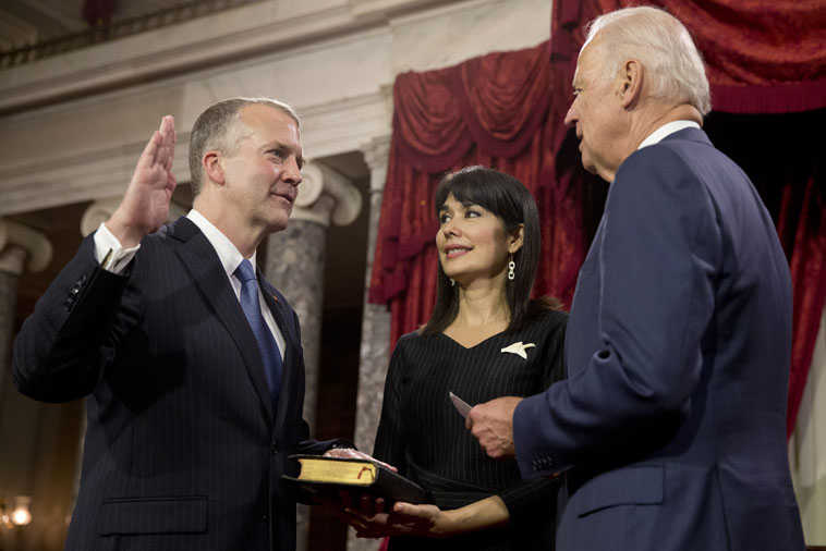 Vice President Joe Biden administers the Senate oath to Sen. Dan Sullivan, R-Alaska, left, with wife Julie Sullivan, during a ceremonial re-enactment swearing-in ceremony, Tuesday, Jan. 6, 2015, in the Old Senate Chamber of Capitol Hill in Washington. (AP Photo/Jacquelyn Martin)