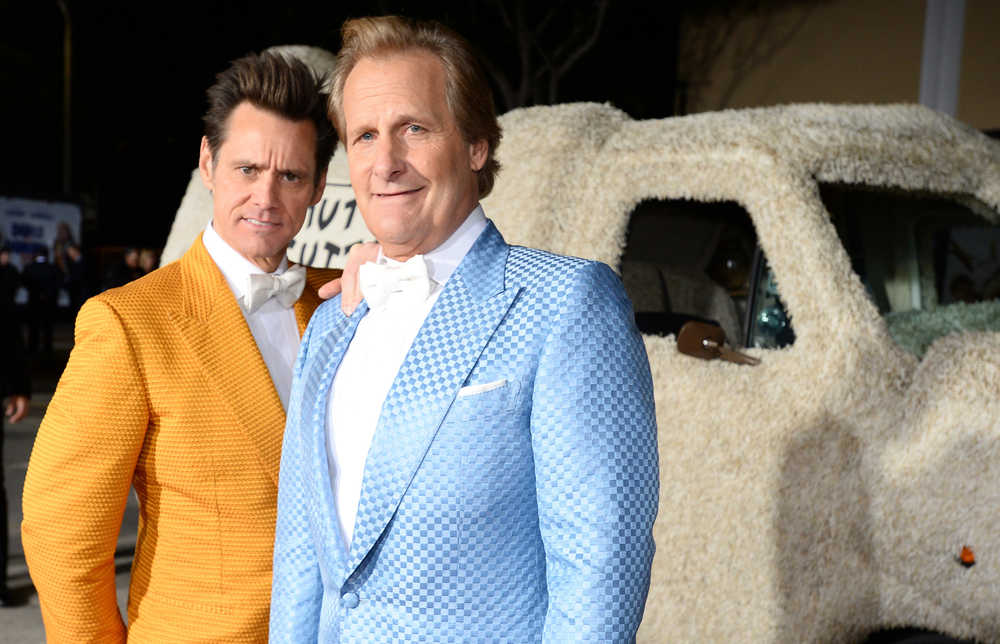 FILE - In this Monday, Nov. 3, 2014 file photo, Jim Carrey, left, and Jeff Daniels arrive at the premiere of "Dumb and Dumber To" at the Regency Village Theatre in Los Angeles. Daniels and Carrey reprise their roles as painfully dim pals Harry and Lloyd in "Dumb & Dumber To," opening Friday, Nov. 14, 2014. Reuniting on a sequel 20 years after the original wasn't hard, Carrey said. (Photo by Jordan Strauss/Invision/AP, File)