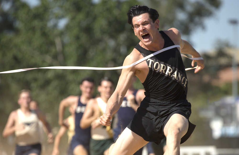 In this image released by Universal Pictures, Jack O'Connell portrays Olympian and war hero Louis "Louie" Zamperini in a scene from "Unbroken." The film, directed by Angelina Jolie, did not receive any Golden Globe nominations on Thursday.  (AP Photo/Universal Pictures, David James)