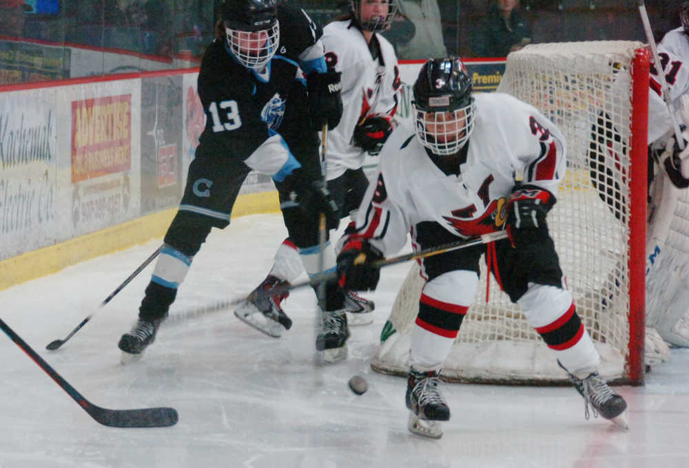 Photo by Kelly Sullivan/ Peninsula Clarion Kenai Central High School's Ian Mercado controls the puck after a scuffle by the goal in the game against Chugiak High School Friday, Jan. 9, 2015, at the Soldotna Regional Sports Complex in Soldotna, Alaska.