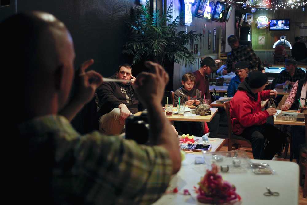 Photo by Rashah McChesney/Peninsula Clarion  Mark Wackler, a guide with Fishology Alaska and Vice President of the Kenai Peninsula Chapter of Trout Unlimited shows an audience how to make a flesh-patterned fly on Tuesday Jan. 6, 2014 at the Main Street Tap & Grill in Kenai, Alaska.